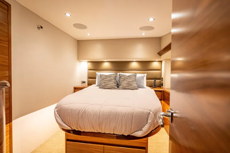 Slide: The Image of Luxurious bedroom interior of 2026 Viking 54 Convertible yacht with modern lighting and cozy bedding. - 44