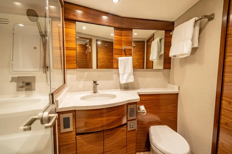 Slide: The Image of Luxurious bathroom in 2026 Viking 54 Convertible yacht with wood accents and modern fixtures. - 49