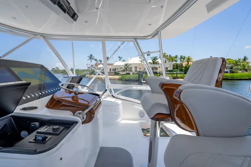 Slide: The Image of Luxurious helm of 2026 Viking 54 Convertible yacht with plush seating and advanced controls. - 59