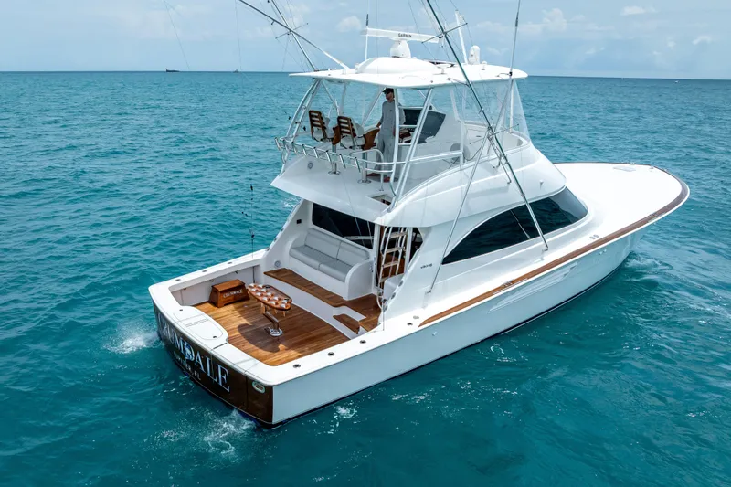 Slide: The Image of 2026 Viking 54 Convertible yacht cruising on open blue sea. - 6