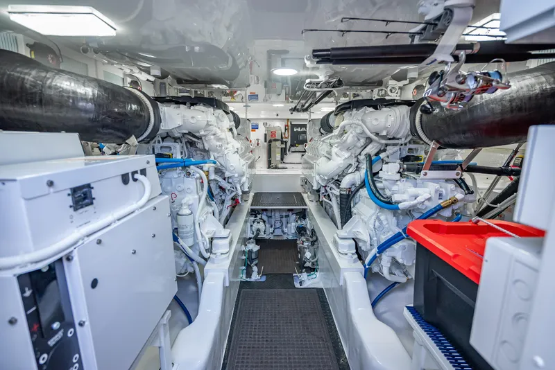 Slide: The Image of Engine room of 2026 Viking 54 Convertible yacht, showcasing dual engines and equipment. - 73