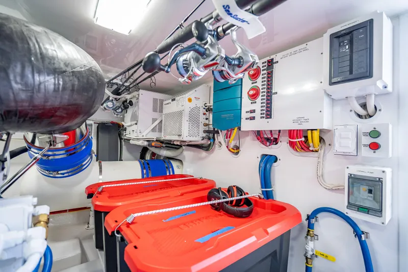 Slide: The Image of Engine room of 2026 Viking 54 Convertible yacht with control panels and equipment. - 76