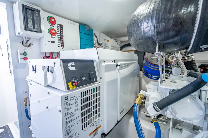 Slide: The Image of Engine room of 2026 Viking 54 Convertible yacht with Cummins generator and control panels. - 78