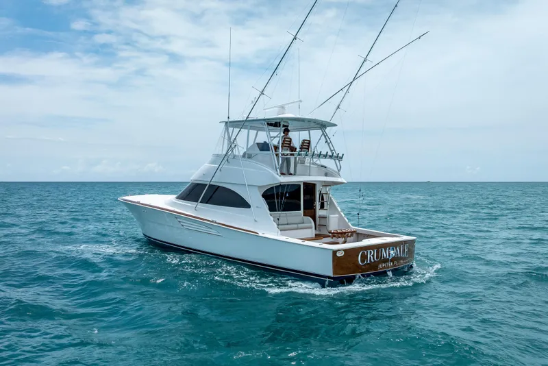 Slide: The Image of 2026 Viking 54 Convertible yacht cruising on open ocean under clear skies. - 8