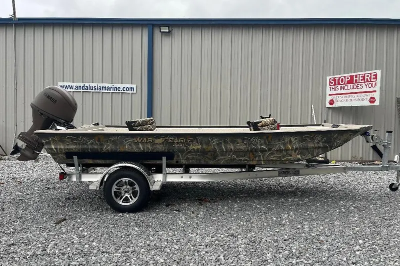The Image of 2026 War Eagle 754VS Stick Steer boat on trailer, parked outside Andalusia Marine. - 1
