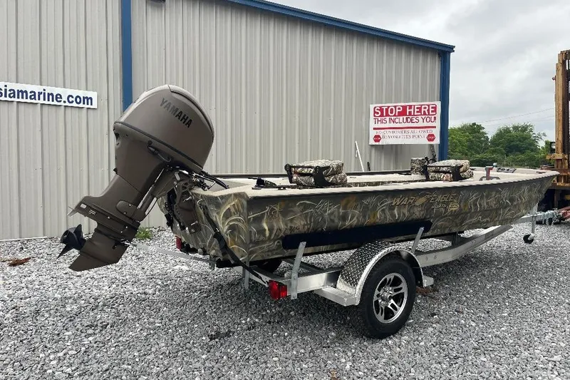 Slide: The Image of 2026 War Eagle 754VS Stick Steer boat with Yamaha motor on trailer, parked outside. - 3