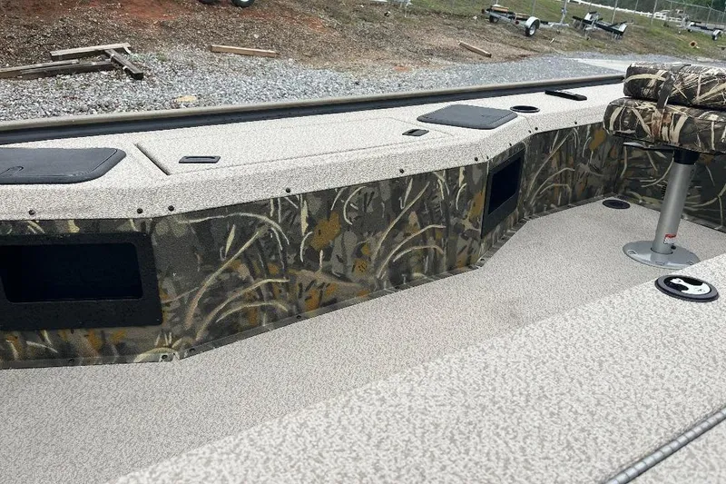 Slide: The Image of 2026 War Eagle 754VS Stick Steer boat interior with camo design and seating. - 7