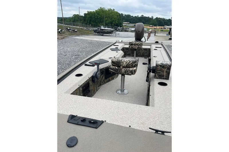 Slide: The Image of 2026 War Eagle 754VS Stick Steer boat with camo seats and steering controls. - 9