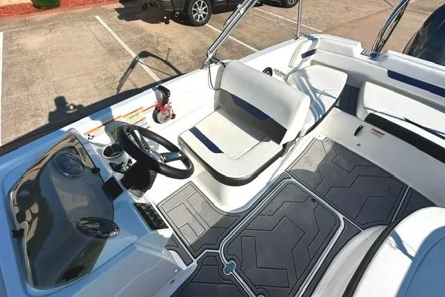 Slide: The Image of 2021 Hurricane SunDeck Sport 185 OB boat interior with steering wheel and seating area. - 10