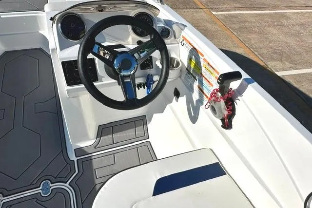 Slide: The Image of 2021 Hurricane SunDeck Sport 185 OB boat cockpit with steering wheel and controls. - 13