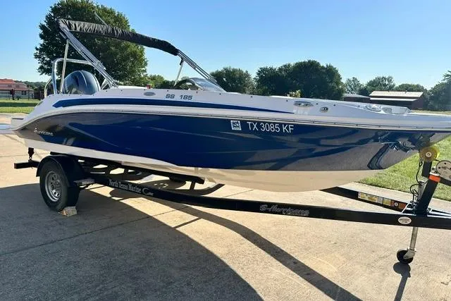 Slide: The Image of 2021 Hurricane SunDeck Sport 185 OB boat on trailer, parked outdoors. - 2