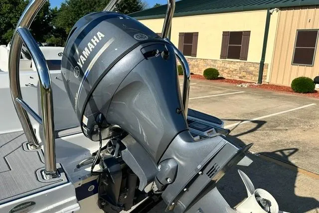 Slide: The Image of 2021 Hurricane SunDeck Sport 185 OB with Yamaha outboard motor in a parking lot. - 5