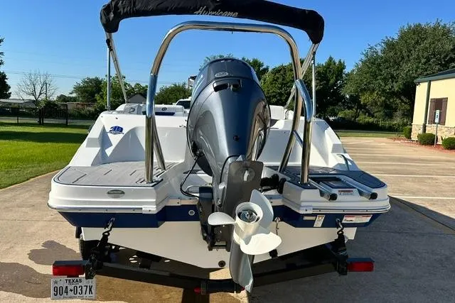 Slide: The Image of 2021 Hurricane SunDeck Sport 185 OB boat, rear view with outboard motor, parked outdoors. - 6