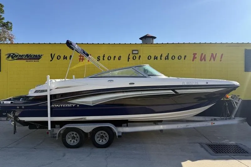 The Image of 2010 Monterey M5 Sport Boat on trailer, parked outside a yellow building. - 0