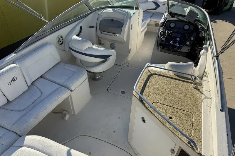 Slide: The Image of 2010 Monterey M5 Sport Boat interior with seating and control panel. - 14
