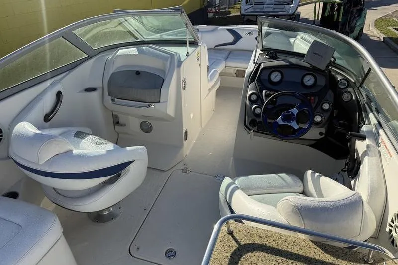 Slide: The Image of 2010 Monterey M5 Sport Boat interior with steering wheel and seating area. - 15