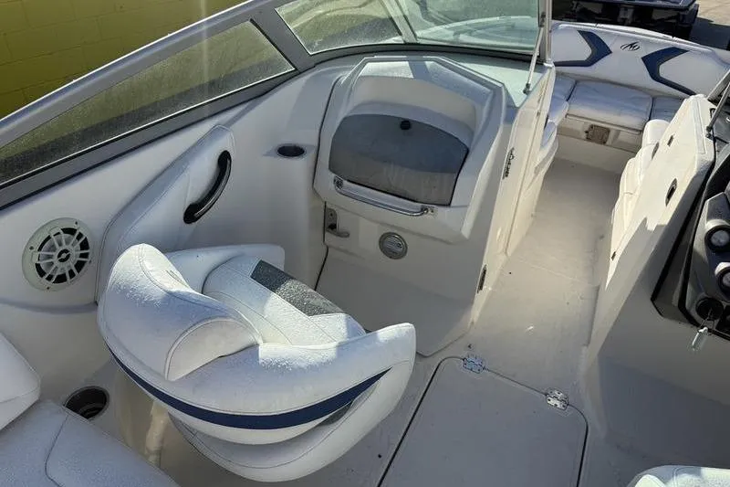 Slide: The Image of 2010 Monterey M5 Sport Boat interior with white seating and modern dashboard design. - 16