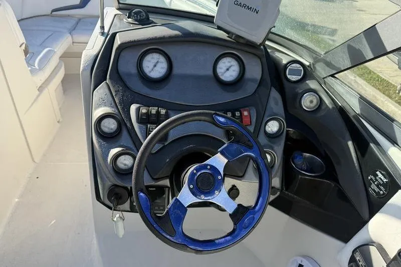 Slide: The Image of Steering console of a 2010 Monterey M5 Sport Boat with gauges and Garmin device. - 19