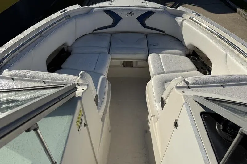 Slide: The Image of 2010 Monterey M5 Sport Boat interior with white cushioned seating and sleek design. - 20