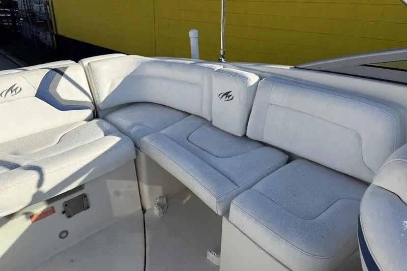 Slide: The Image of 2010 Monterey M5 Sport Boat interior seating with white cushioned seats. - 7