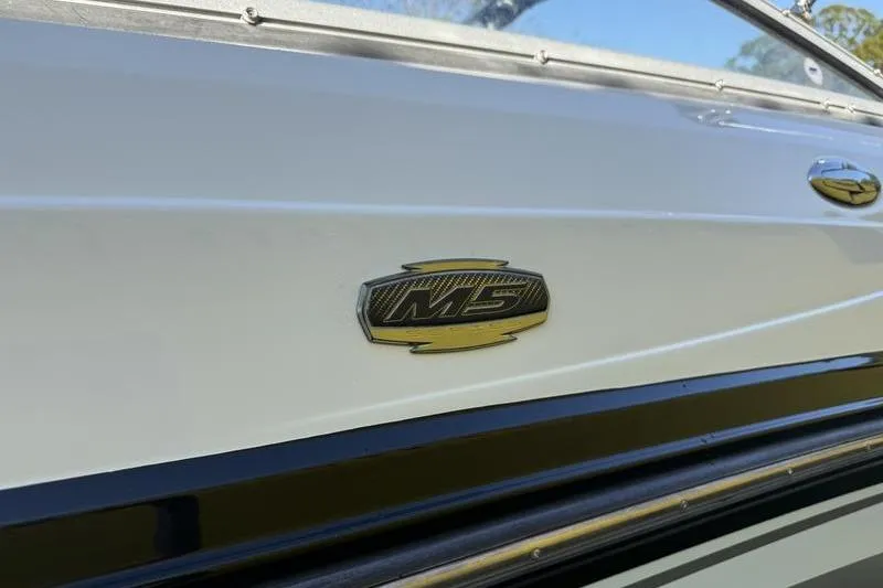 Slide: The Image of 2010 Monterey M5 Sport Boat emblem on sleek white hull. - 8
