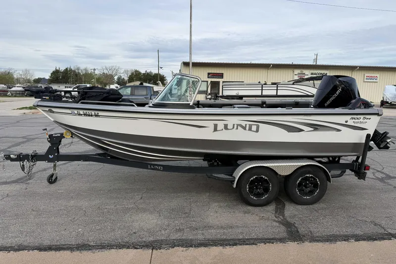 The Image of 2019 Lund 1950 Tyee Magnum ITS boat on trailer, parked outdoors. - 1