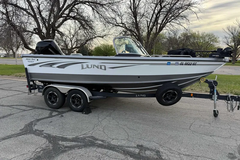 Slide: The Image of 2019 Lund 1950 Tyee Magnum ITS boat on trailer, parked outdoors. - 8