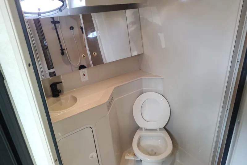 Slide: The Image of Bathroom interior of 1998 Cruisers Yachts 3870 Express with shower and toilet. - 26