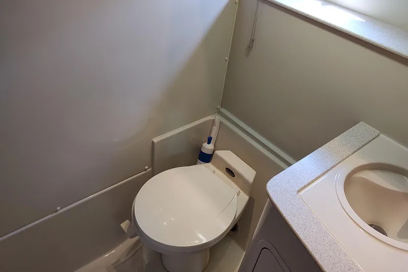 Slide: The Image of Bathroom interior of 1998 Cruisers Yachts 3870 Express with toilet and sink. - 29