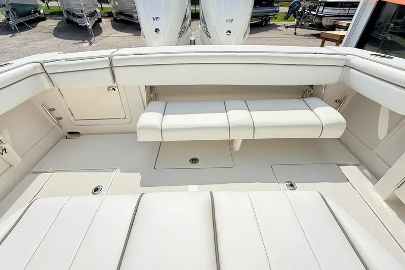 Slide: The Image of 2012 Jupiter 34 FS boat interior with white seating and storage compartments. - 10