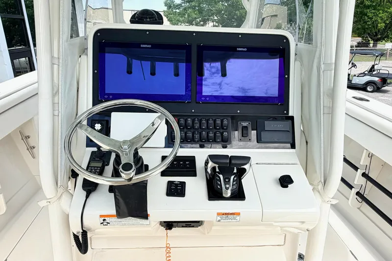 Slide: The Image of Control panel of a 2012 Jupiter 34 FS boat with dual Simrad displays. - 14