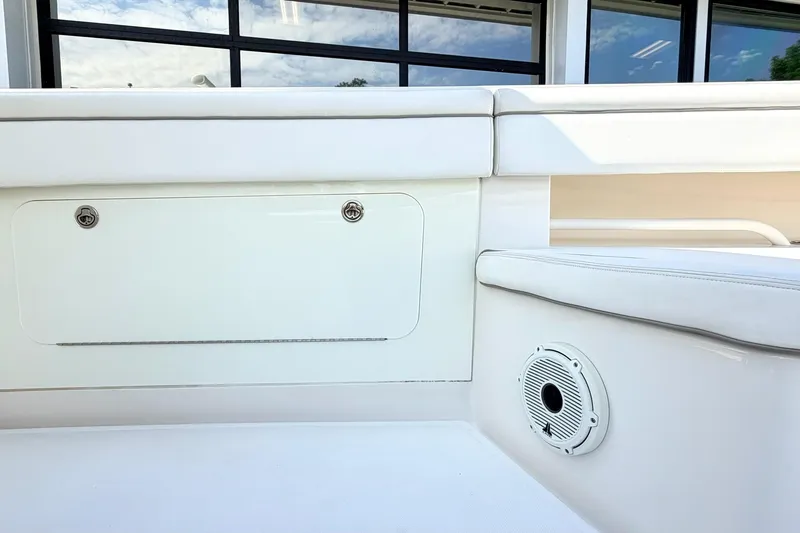 Slide: The Image of 2012 Jupiter 34 FS boat interior with white seating and speaker detail. - 18