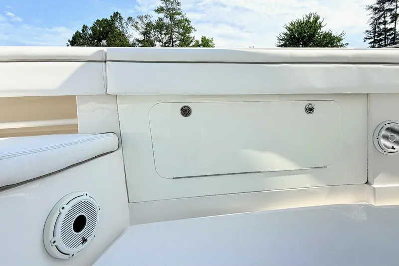 Slide: The Image of 2012 Jupiter 34 FS boat interior with white seating and speaker system. - 19