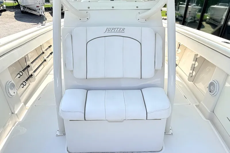 Slide: The Image of 2012 Jupiter 34 FS boat interior with white seating and rod holders. - 20
