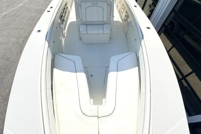 Slide: The Image of 2012 Jupiter 34 FS boat interior with white seating and clean deck. - 22