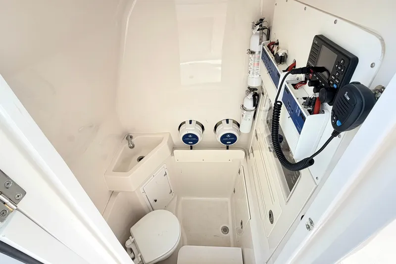 Slide: The Image of Interior of 2012 Jupiter 34 FS boat with sink, toilet, and communication equipment. - 25