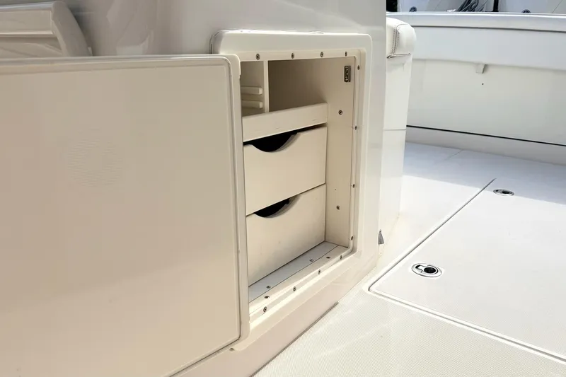 Slide: The Image of Storage compartment on a 2012 Jupiter 34 FS boat, featuring built-in drawers. - 26
