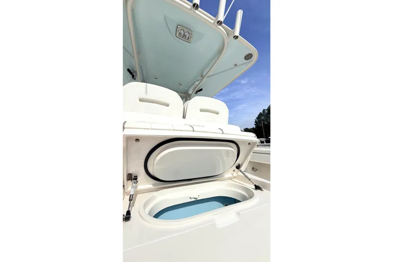 Slide: The Image of 2012 Jupiter 34 FS boat with open storage compartment under clear blue sky. - 27