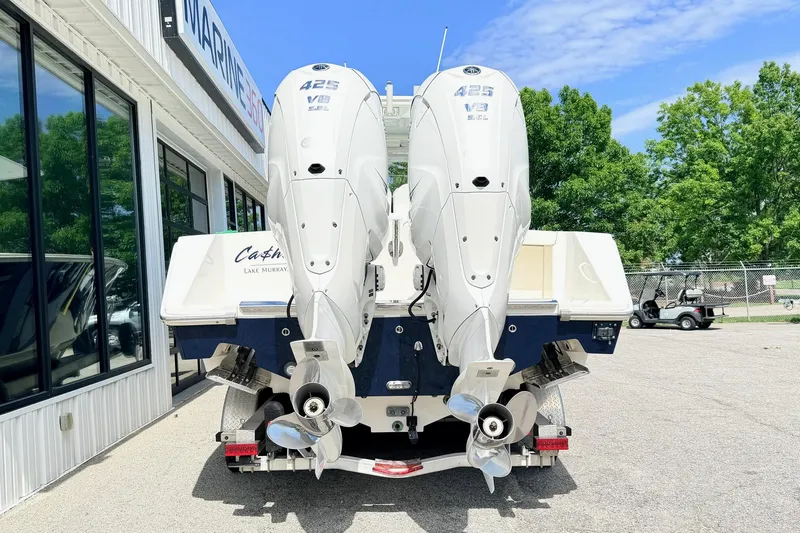 Slide: The Image of 2012 Jupiter 34 FS boat with twin 425 V8 engines, parked outdoors. - 3