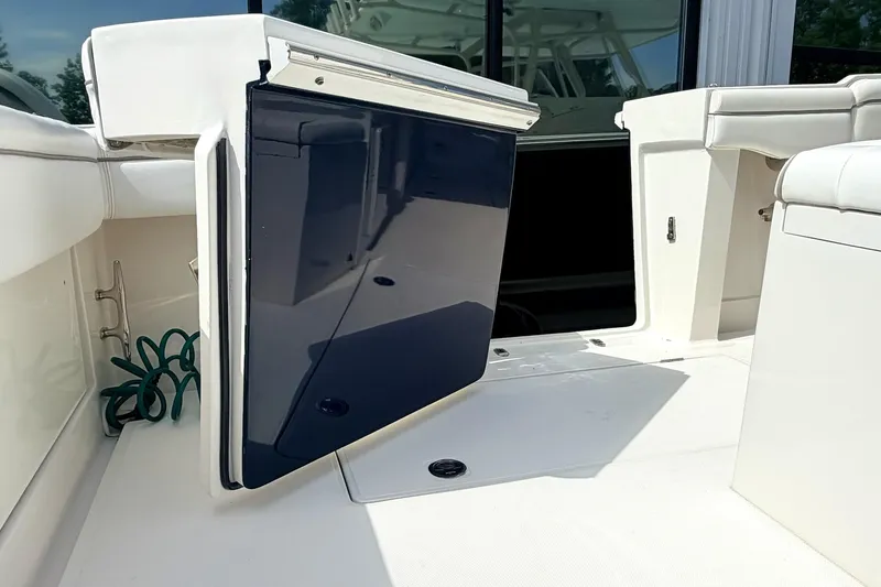Slide: The Image of 2012 Jupiter 34 FS boat interior with open storage compartment and seating. - 4