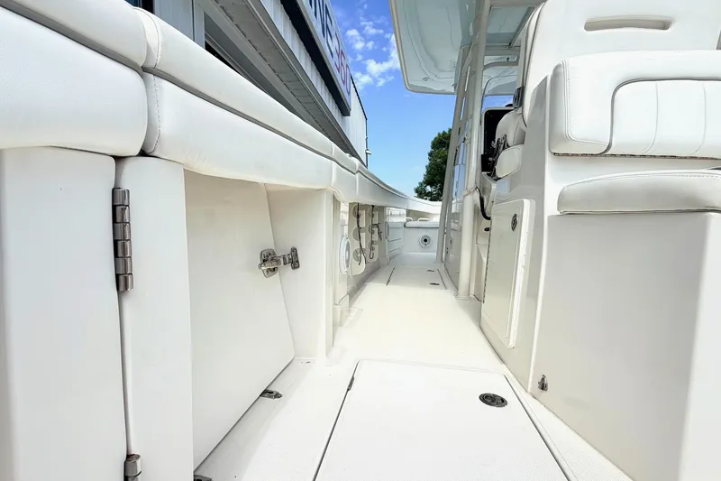 Slide: The Image of 2012 Jupiter 34 FS boat interior with white seating and storage compartments. - 7