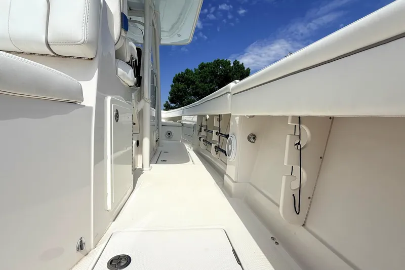 Slide: The Image of 2012 Jupiter 34 FS boat interior with white seating and clear blue sky. - 8