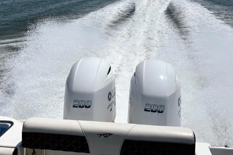 Slide: The Image of Twin 200 horsepower engines on a 2021 Tidewater 256 CC Adventure boat in motion. - 3