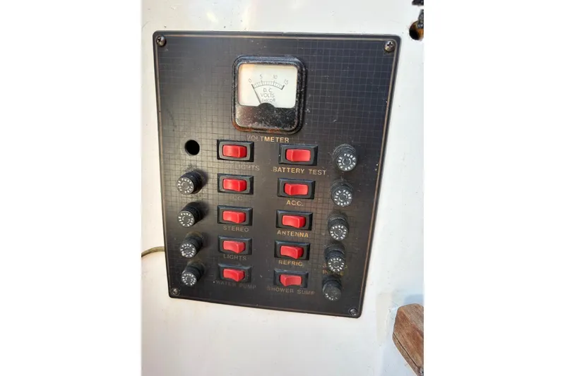 Slide: The Image of Control panel of a 1987 Four Winns 245 Vista boat with voltmeter and switches. - 6
