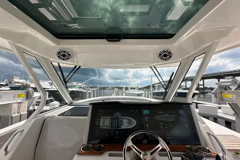 Slide: The Image of Interior view of 2025 Regal 38 SAV boat cockpit with advanced navigation system. - 12