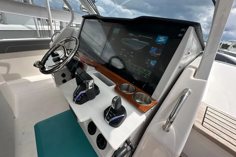 Slide: The Image of 2025 Regal 38 SAV helm with advanced touchscreen controls and sleek steering wheel design. - 13