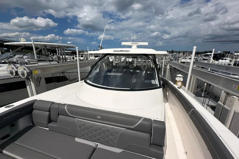 Slide: The Image of 2025 Regal 38 SAV boat docked under a partly cloudy sky. - 17
