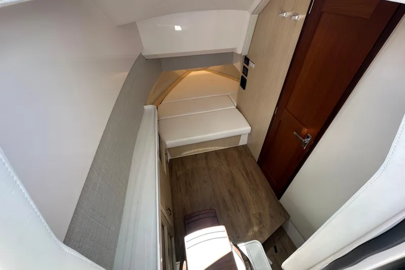 Slide: The Image of Interior cabin of 2025 Regal 38 SAV boat with wood flooring and cozy seating. - 20