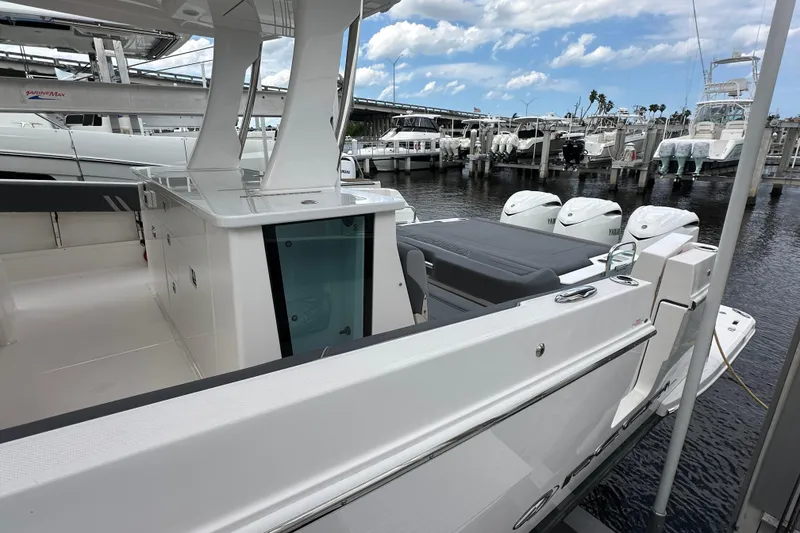 Slide: The Image of 2025 Regal 38 SAV luxury boat docked, showcasing sleek design and powerful engines. - 4