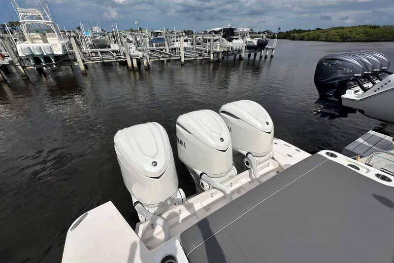 Slide: The Image of Triple Yamaha outboard engines on a 2025 Regal 38 SAV boat at a marina. - 5